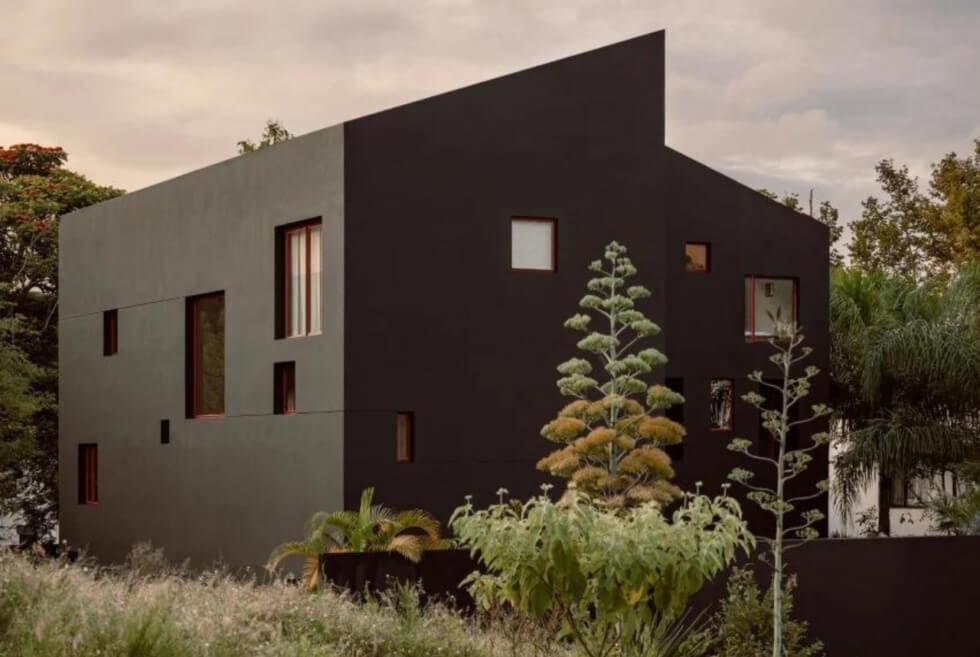House of Xalapa Stands Like A Monolith Against A Backdrop Of Greenery