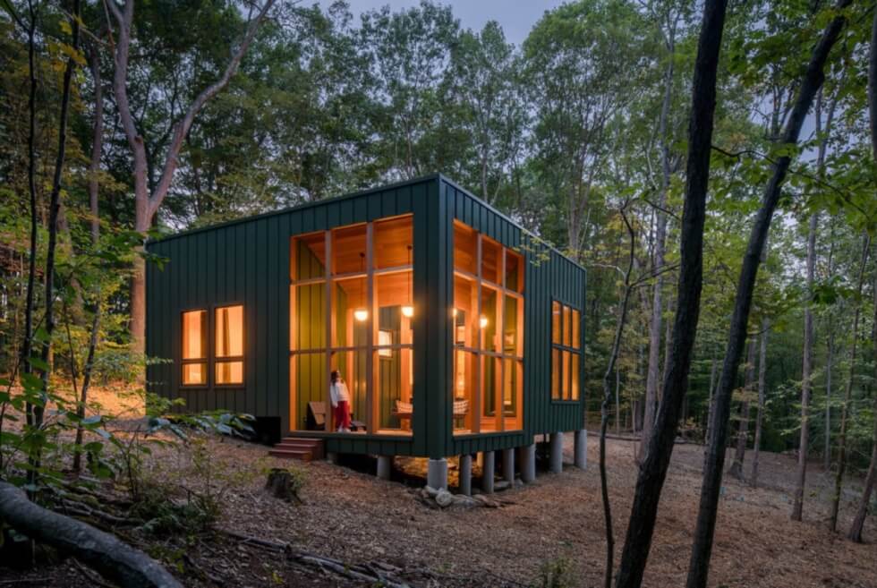 The Forest Retreat Is A Green Hovering Box With A Concaved Roof