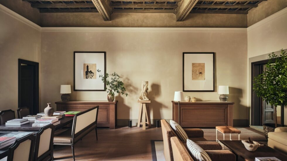 Living and dining room inside La Réserve Firenze with a coffered ceiling and contemporary furniture